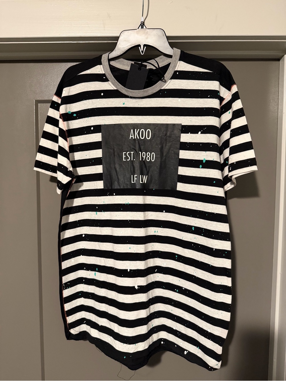 AKOO Black & White Striped Tee with Teal Paint Splatter